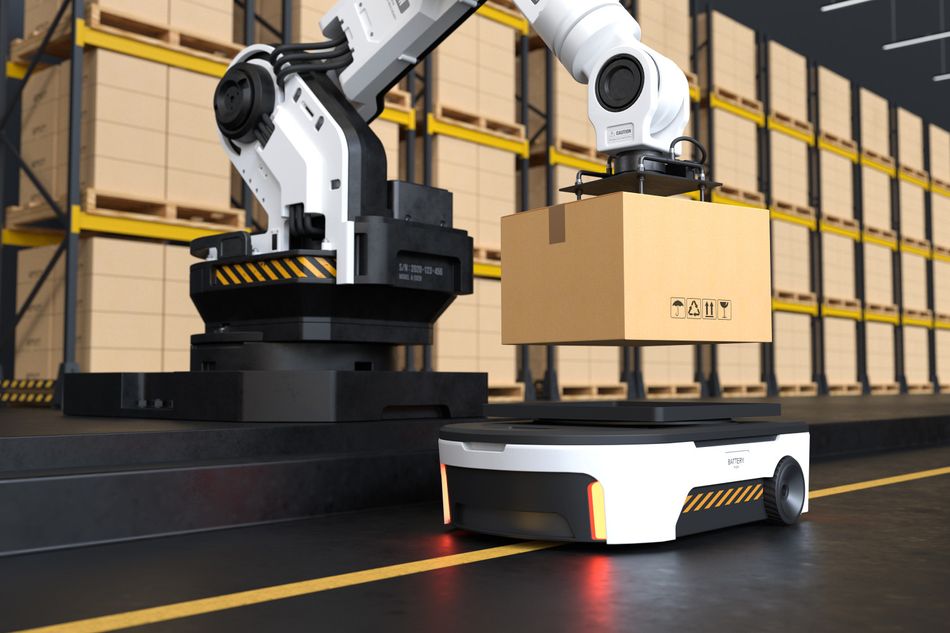 Robotic arm picking up the box for autonomous robot transportation in a warehouse.