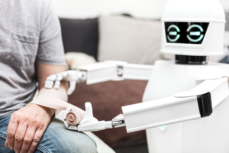 Assistance medicine service robot putting a bandage on the arm of a patient.