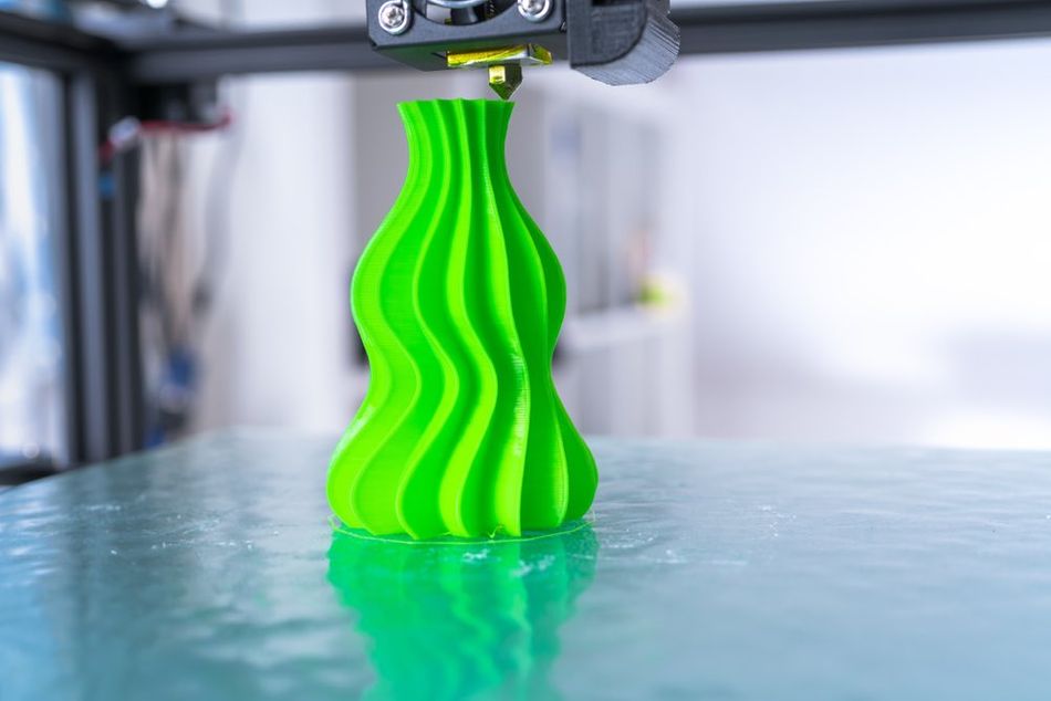 Green vase on 3D printer bed