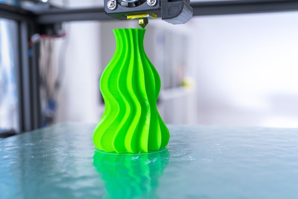 Green vase on 3D printer bed