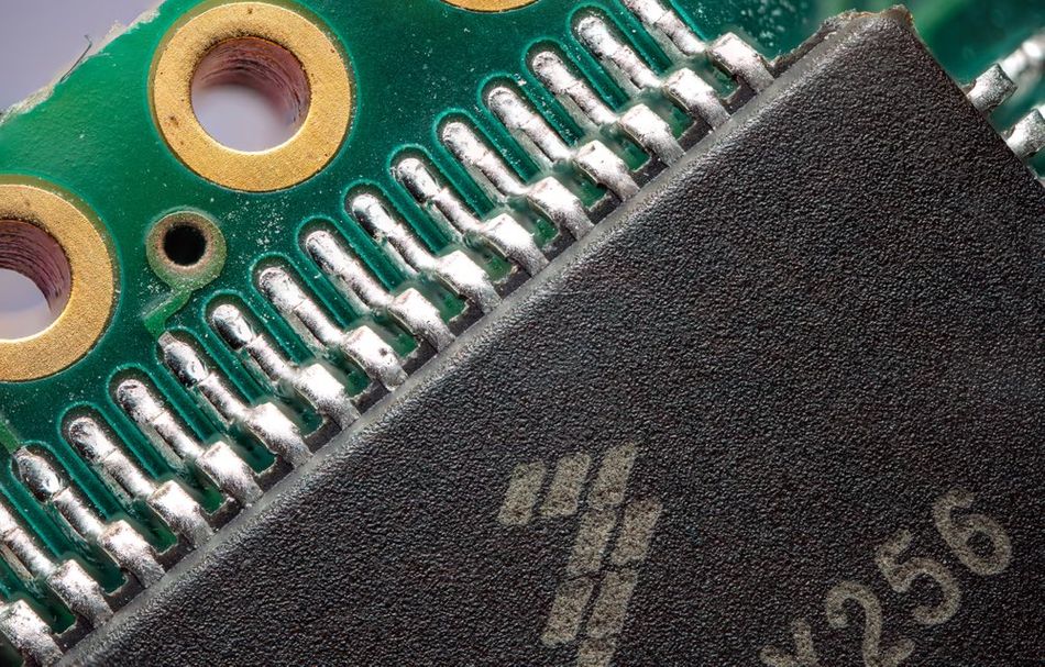 An illustration demonstrating a detailed view of a printed circuit board (PCB) featuring an integrated QFN surface-mount device (SMD) package.