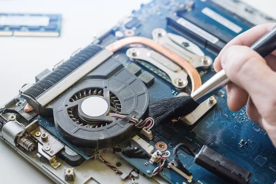 Airborne debris caught by the onboard fan on a notebook motherboard. 