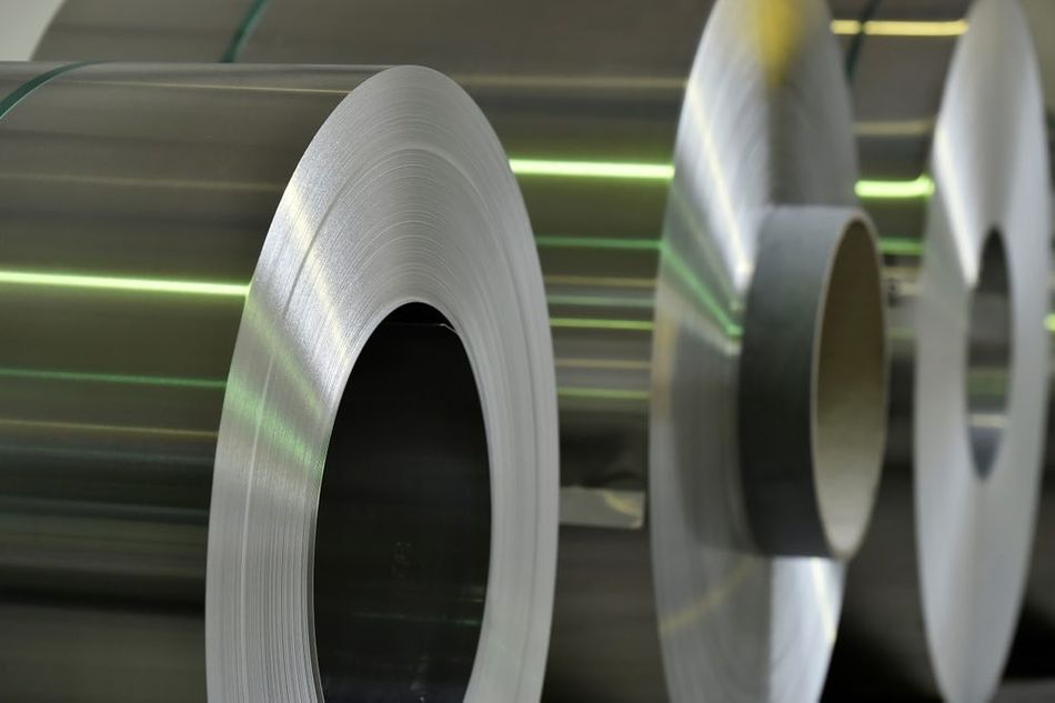 Several big rolls of steel in a factory
