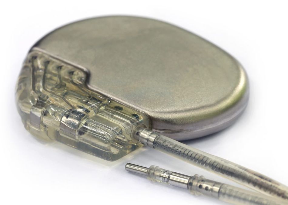 A close-up view of pacemaker with cable connectors on a white background.