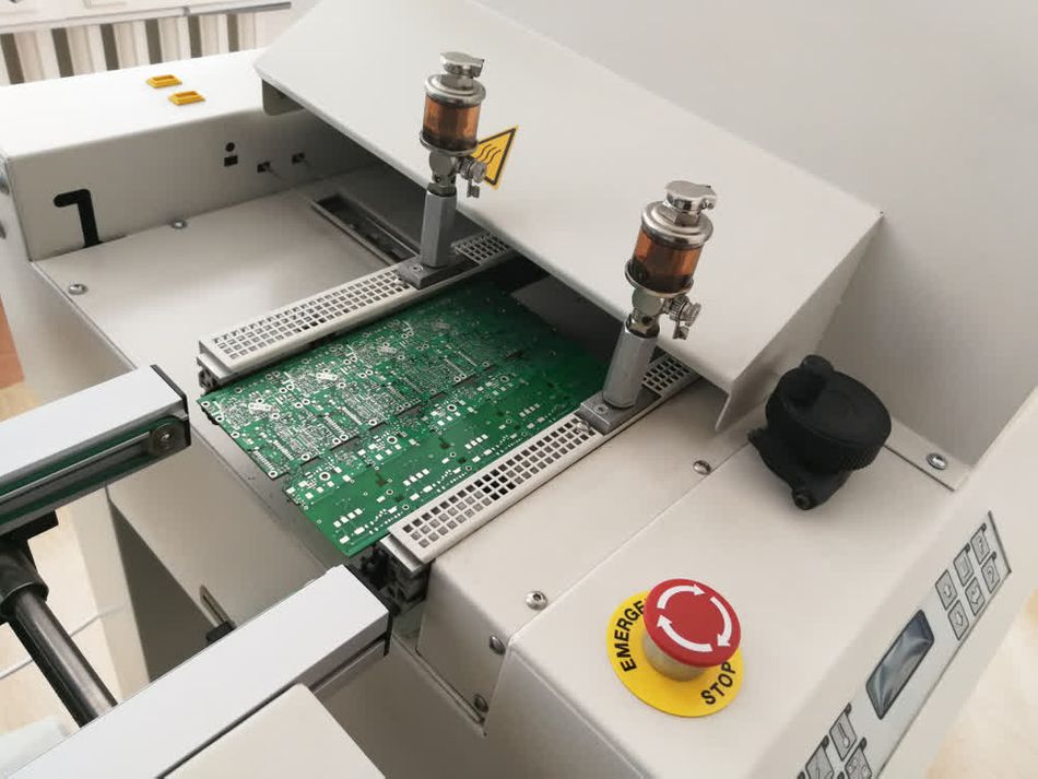 A PCB moving inside a solder reflow oven after assembly