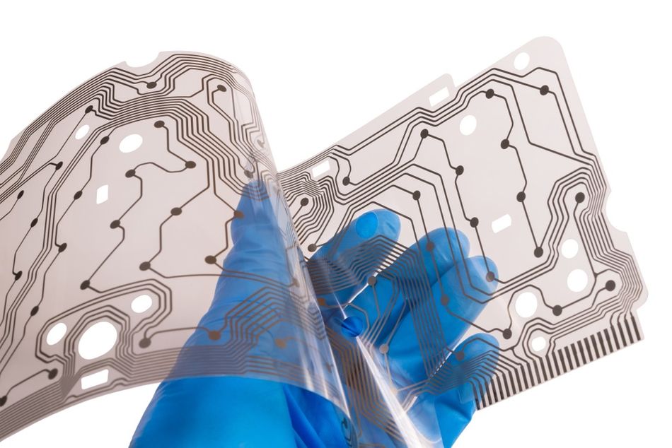 An engineer demonstrates the flexibility of a keyboard PCB