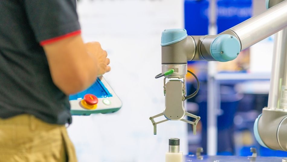 A Collaborative Robot works works with an engineer