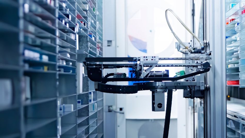 Robotic hands sorting and arranging drugs in a pharmacy