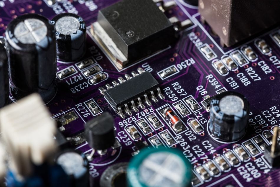 A PCB featuring through-hole devices (Capacitors) and Surface mount devices 