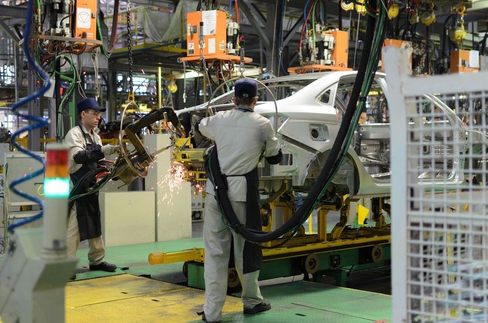 Cobots assisting humans on a car assembly line