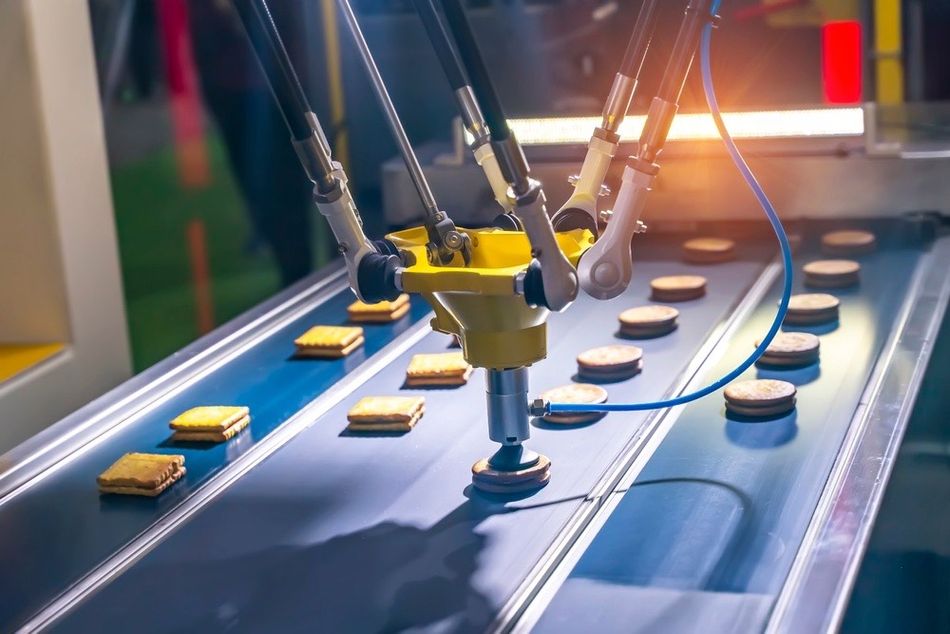 A delta robot in a food manufacturing assembly line.