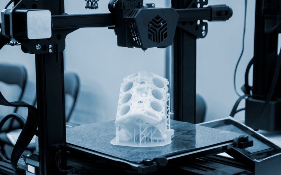 Image of 3D printing technology with temporary support structures to maintain stability of printed parts.