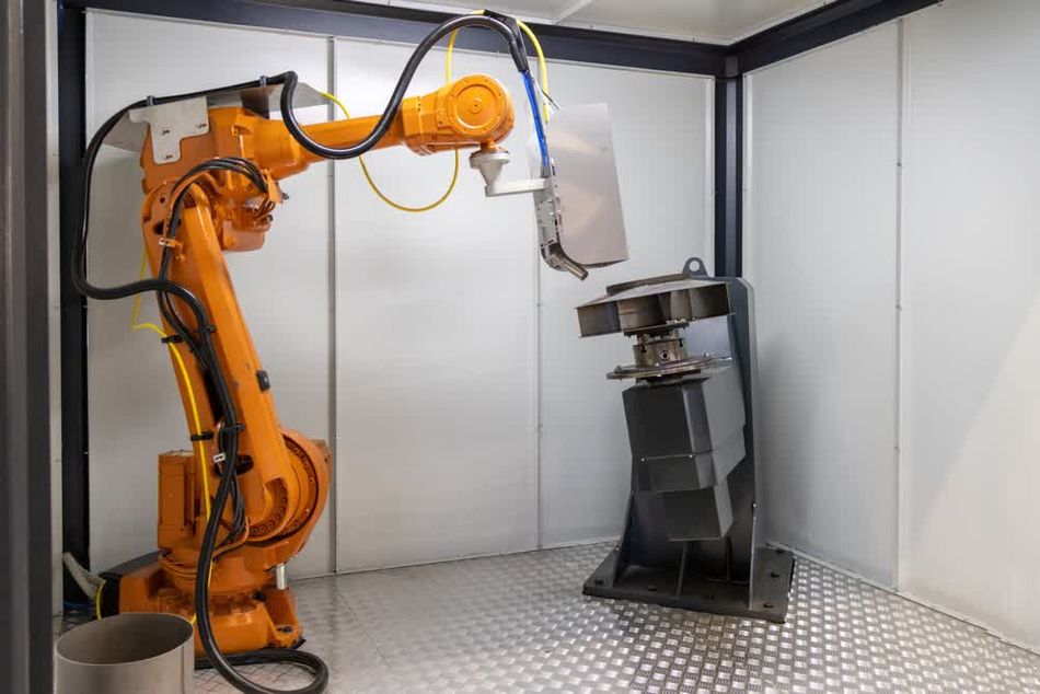 A close-up of a robotic arm equipped with a welding torch, performing precise welding operations in a high-tech industrial environment. Blue sparks fly as the robot seamlessly joins metal components