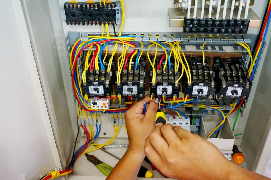 A technician performing contactor maintenance in a MCC bucket.