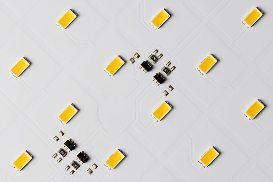 Top View of White Aluminum Printed Circuit Board with SMD LEDs and Microchips