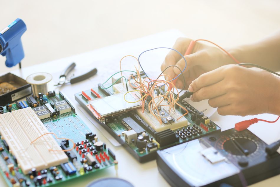 Printed Circuit Board being tested using Multimeter
