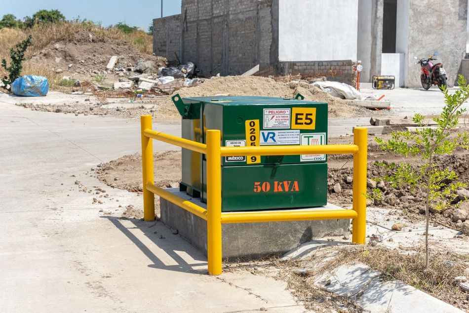 A transformer mounted on a pad with protective yellow bars for shock prevention