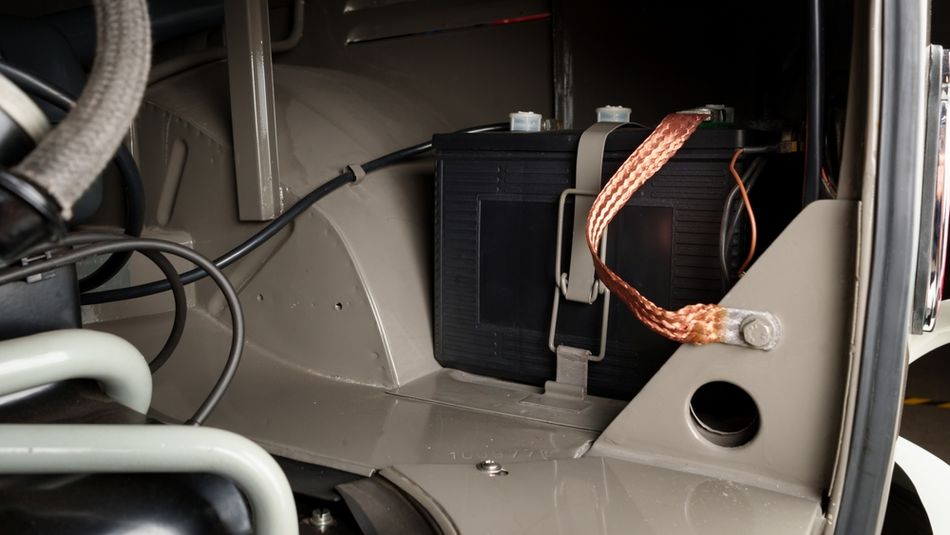 Copper ground strap connected to a car’s body