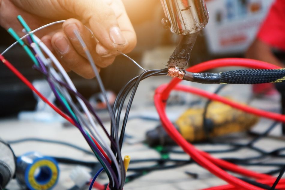 Car Audio Technician Soldering Wires