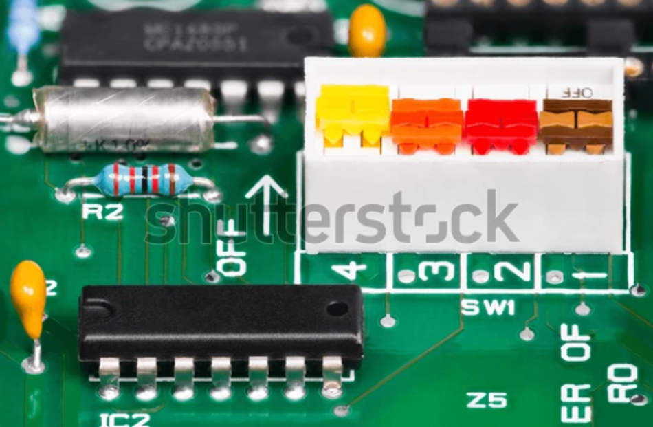 A colored 4-bit DIP switch tied to the input of a logic circuit