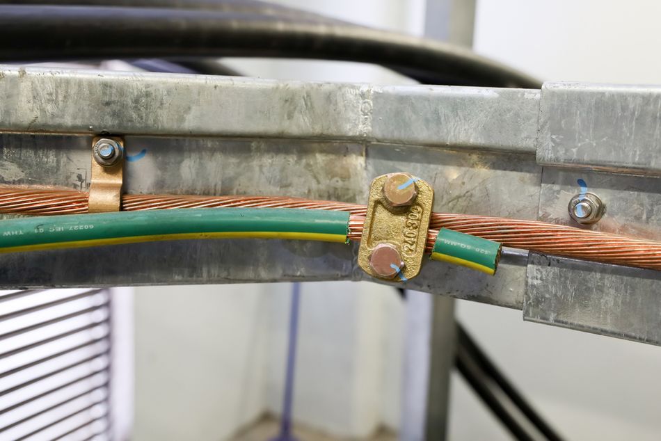Bare copper cable chassis grounded for electrical safety