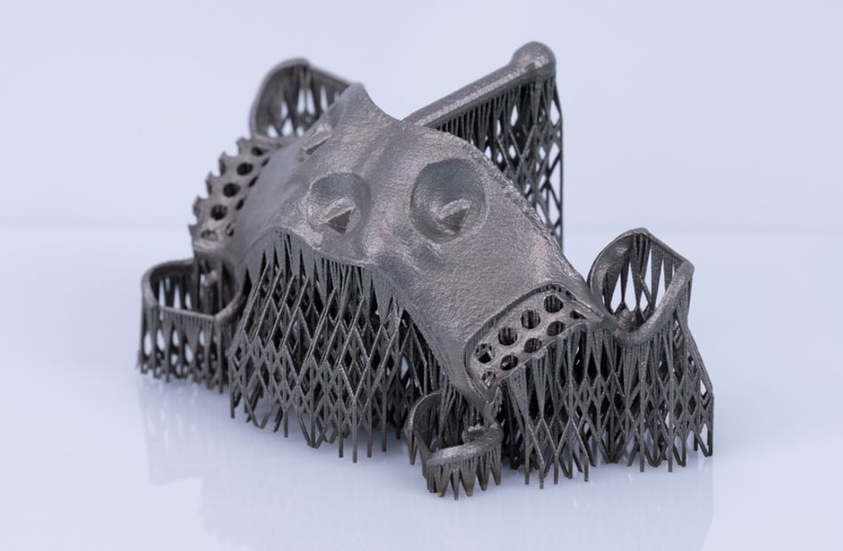 A 3D printed dental part with several support structures.