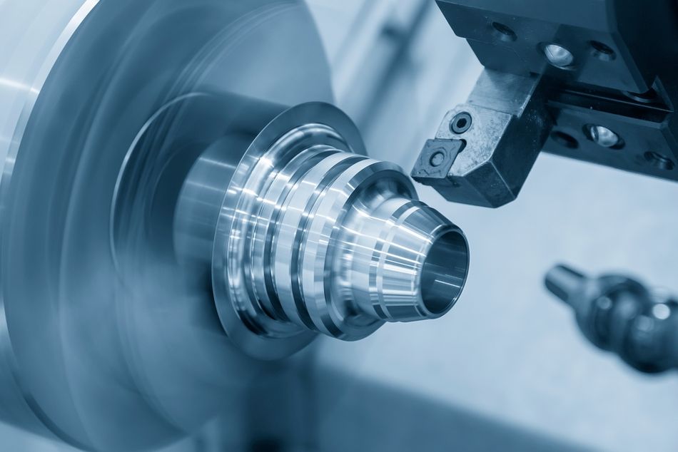 A lathe cuts a metal part