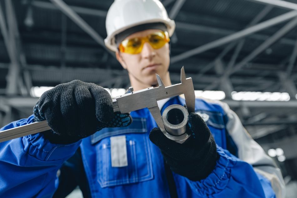 Engineer inspects a part with callipers