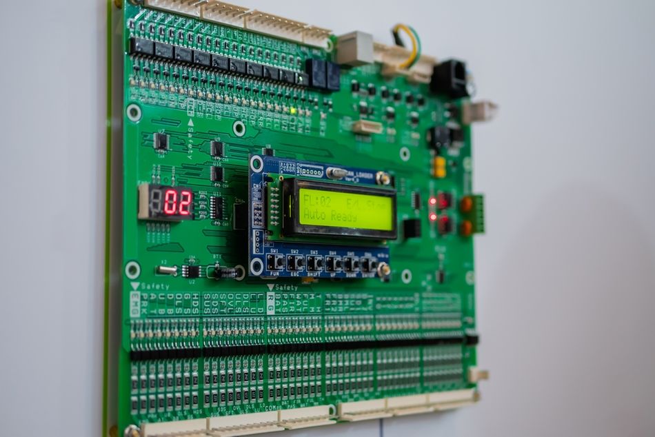 Electronic control board with integrated circuits, connectors, and display components.
