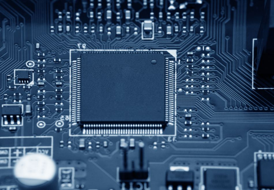 Electronic circuit board with an integrated processor illustrating the semiconductor circuitry used to implement CMOS Schmitt trigger devices.