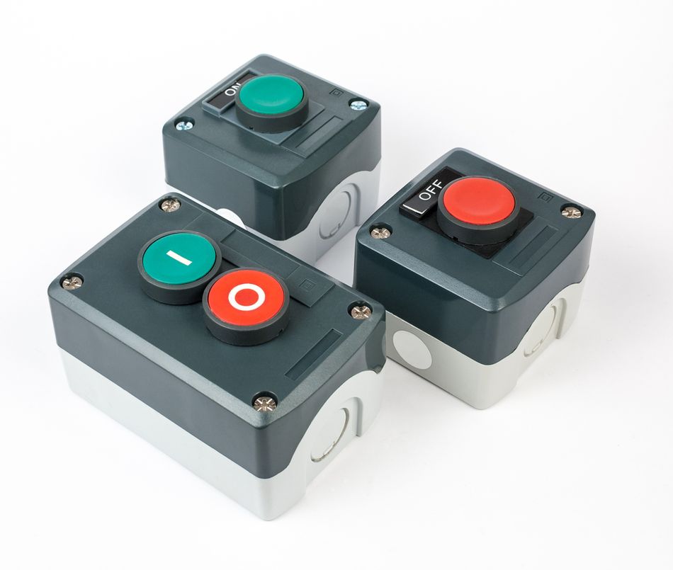 Industrial push-button start-stop station illustrating a mechanical switch that can produce contact bounce.