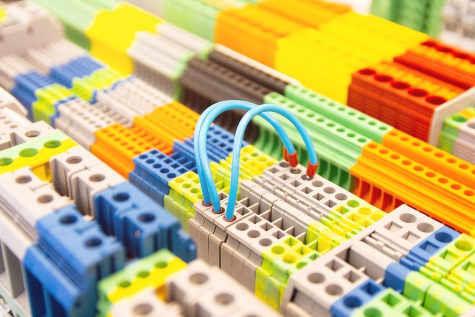 Different types of DIN rail terminal blocks arranged for electrical connection, showing variations in terminal design and configuration.  