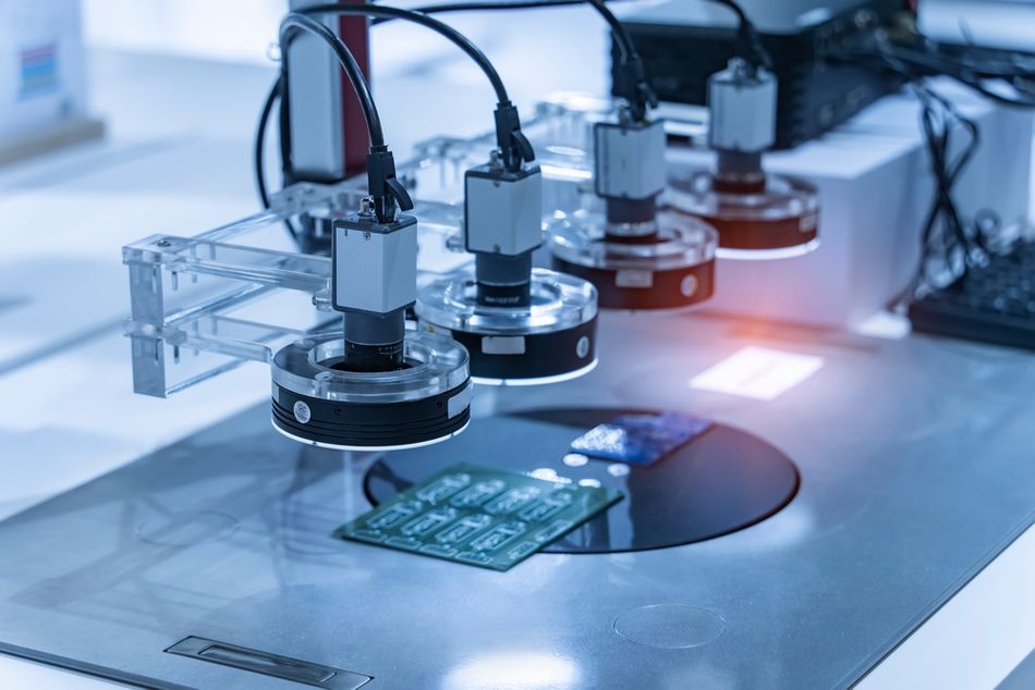 A machine vision system inspectin a PCB