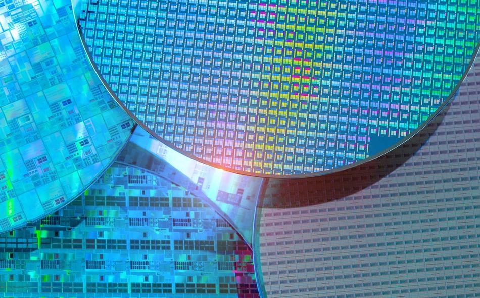 Close-up photograph of a silicon semiconductor wafer, a thin slice of crystalline silicon used as the substrate for manufacturing integrated circuits and microchips. Silicon wafers undergo precision fabrication processes, including lithography, etching, and doping, to form the electronic structures that enable transistors and other semiconductor devices to control electrical signals.