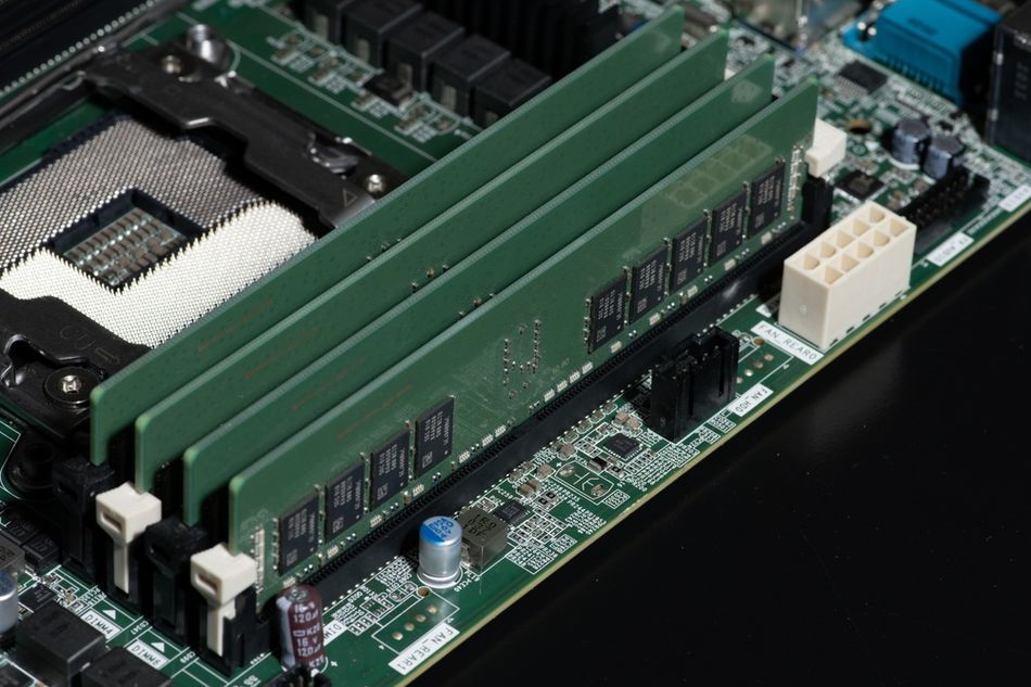 Photograph of DDR RAM memory modules featuring semiconductor chips mounted on printed circuit boards with electrical contacts for installation in a computer system. These modules provide random-access memory (RAM), which temporarily stores the data and instructions a processor needs while applications are running. The image illustrates how semiconductor devices are integrated into computer hardware to support data processing and system performance.