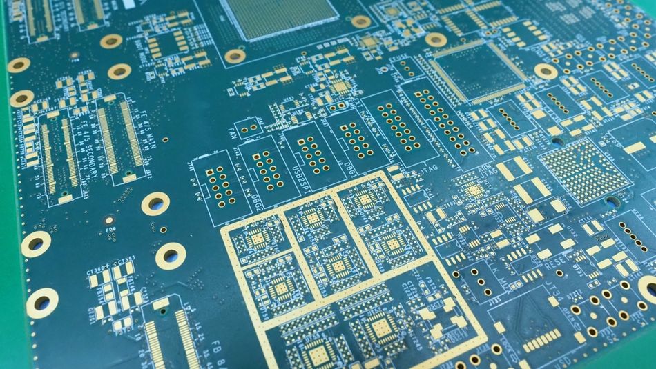 A green printed circuit board with conductive traces, copper pads, and component footprints. Trace geometry, spacing, via transitions, and the continuity of the reference plane can affect characteristic impedance and signal integrity in high-speed PCB designs.