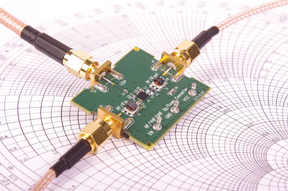 Photograph of a printed circuit board connected to cables for evaluation and electrical testing. In controlled-impedance PCB manufacturing, test equipment such as a time-domain reflectometer (TDR) can measure characteristic impedance by sending a fast electrical signal through a test structure and analyzing reflections caused by impedance changes. Test results help determine whether the fabricated structure meets its specified impedance tolerance.