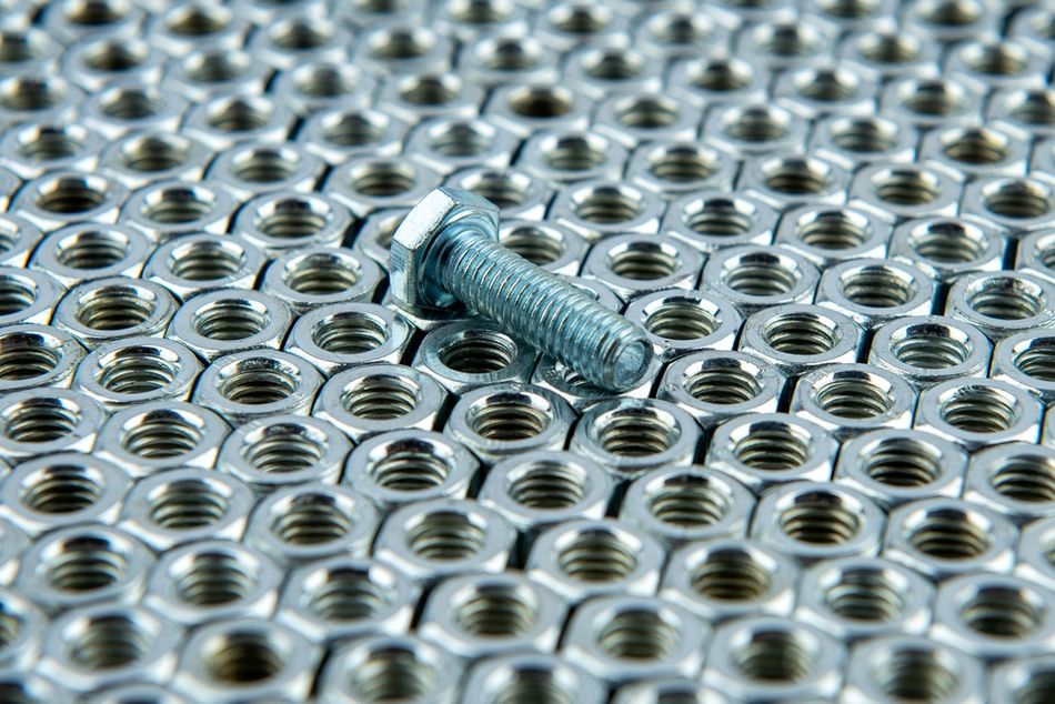 Many identical metal fasteners