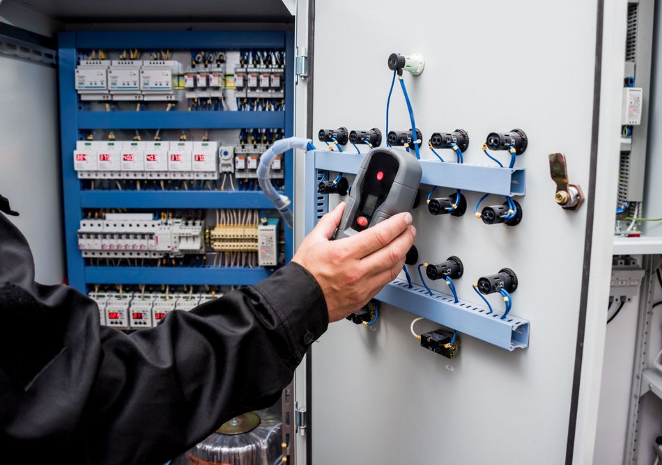 Electrical Measurements with Multimeter Tester in an Industrial Control Panel